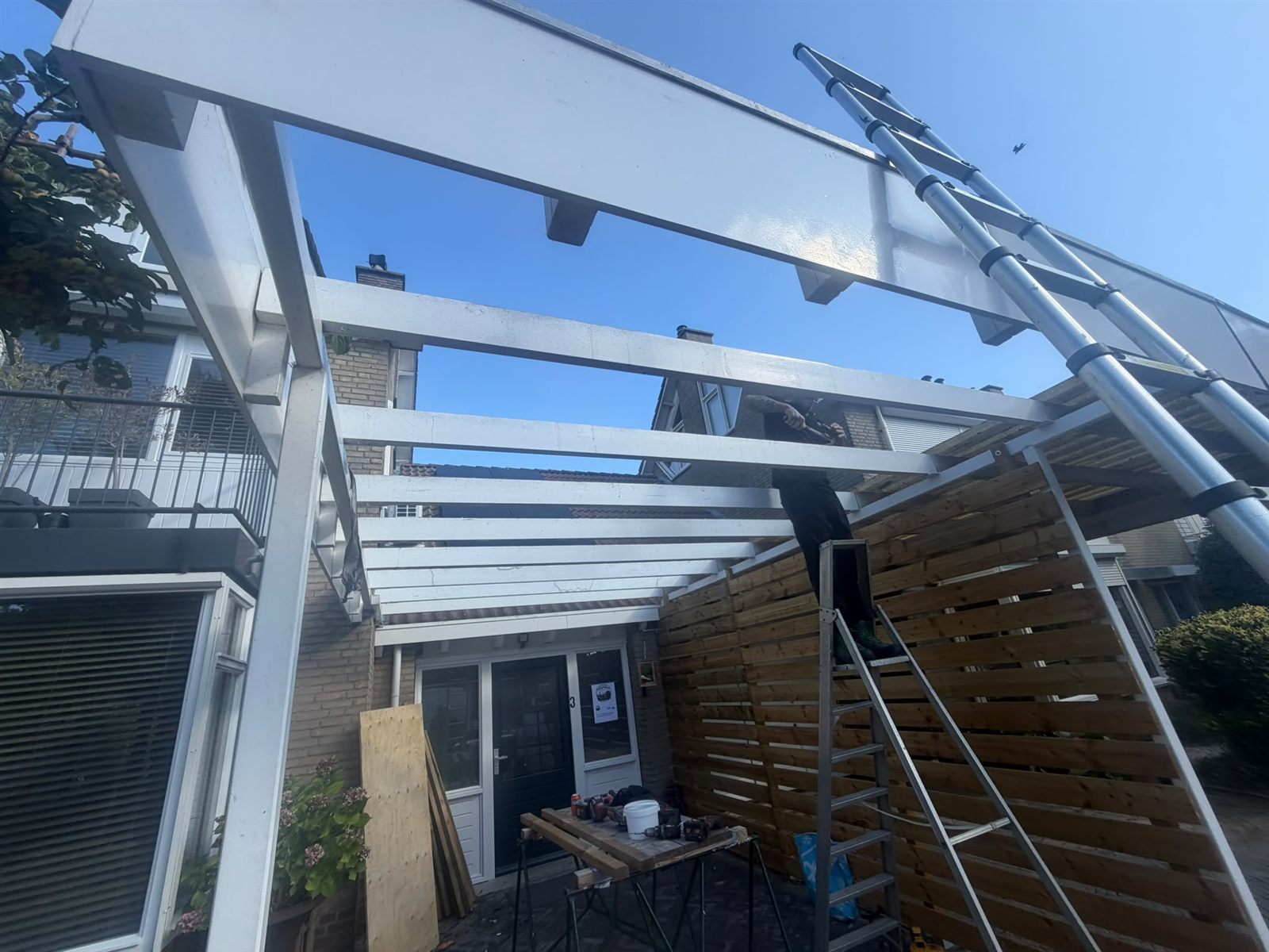 Werkzaamheden aan de balkconstructie van een terrasoverkapping